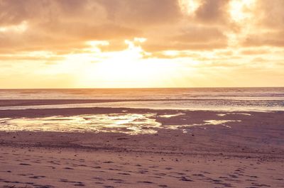 Scenic view of beach against sky during sunset