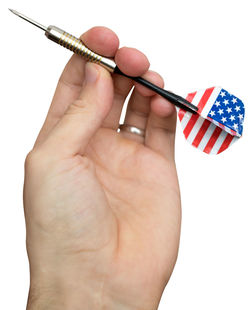 Close-up of hand holding colored pencils against white background