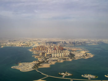 High angle view of city against cloudy sky