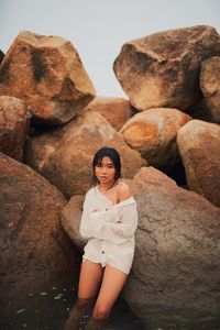 Portrait of woman standing on rock