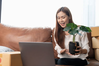 Young woman using laptop at home