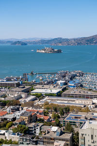 High angle view of townscape by sea against sky