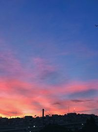 Silhouette buildings against sky during sunset