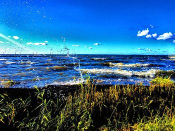 Scenic view of sea against blue sky