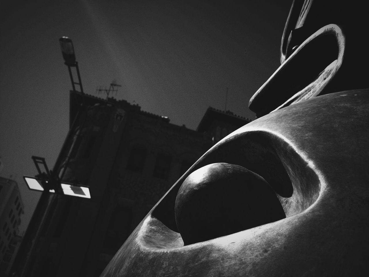 low angle view, built structure, architecture, building exterior, sky, old, outdoors, clear sky, no people, abandoned, night, damaged, sunlight, building, street light, religion, lighting equipment, dusk, industry