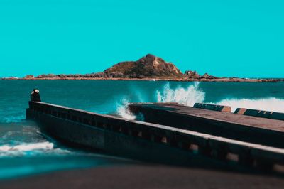 Scenic view of sea against clear blue sky