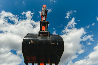 Low angle view of bulldozer against sky