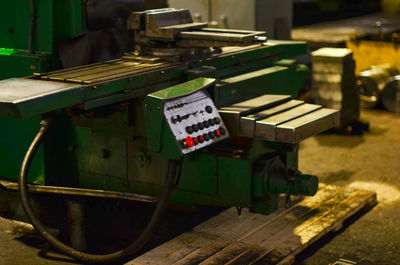 Close-up of old machine part on table