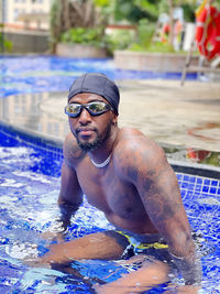 Portrait of young man swimming in pool