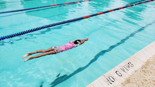 High angle view of woman swimming in pool