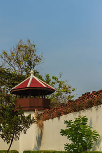 Low angle view of house and trees against sky