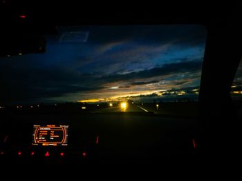 Illuminated car against sky at night