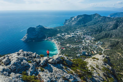 Scenic view of sea and mountain against sky