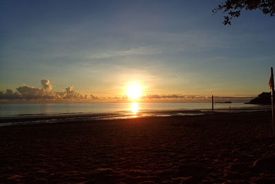 Scenic view of beach against sky during sunset