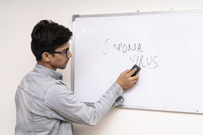 Midsection of man holding paper with text