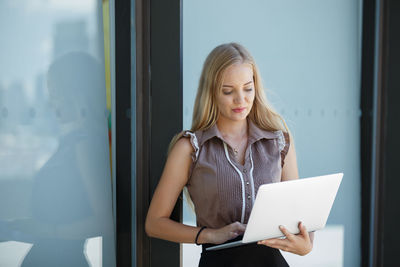 Young woman looking through mobile phone