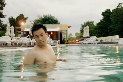 Portrait of shirtless man in swimming pool