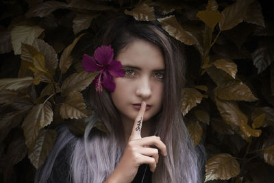 Portrait of a beautiful young woman with leaves