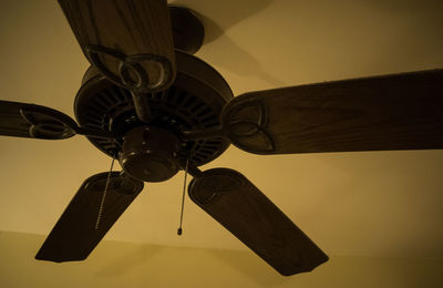 Low angle view of electric fan against sky