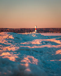 The pier covered in ice leading to the light house in petoskey michigan