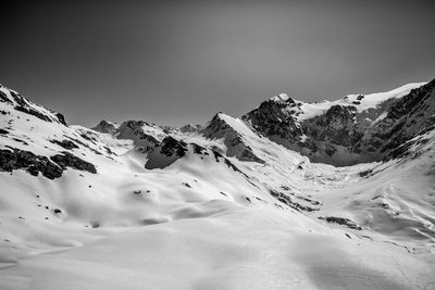 Scenic view of snow covered mountains against sky