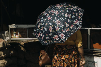 Rear view of women standing at night