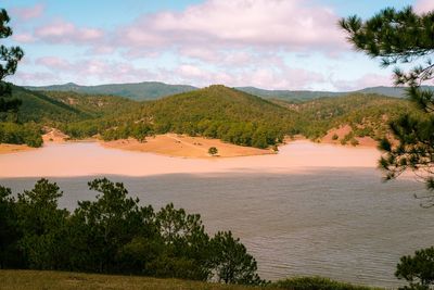 Scenic view of sea and mountains against sky