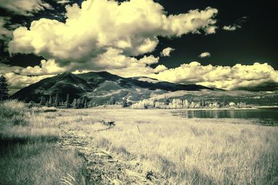 Scenic view of mountains against cloudy sky