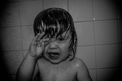 Close-up of shirtless boy in bathroom