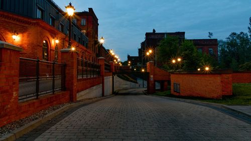 Street amidst buildings at night