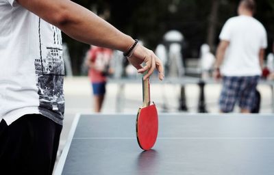 Midsection of man playing table tennis