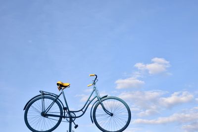 Close-up of bicycle against blue sky