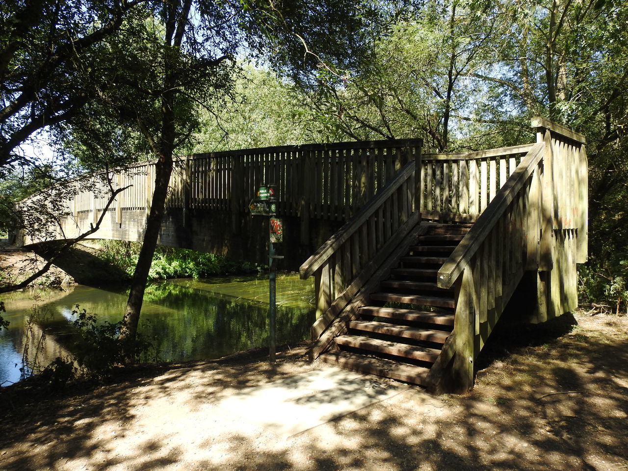 WOODEN FOOTBRIDGE OVER STREAM IN FOREST