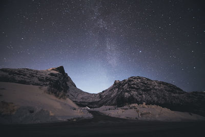 Scenic view of mountains against star field at night