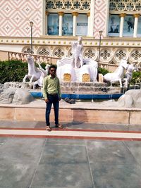 Full length of man statue against fountain in city