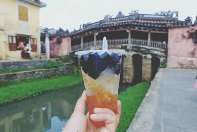 Close-up of hand holding ice cream in city