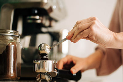 Midsection of man preparing food in kitchen at home