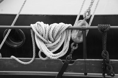 Close-up of rope tied on boat moored at harbor