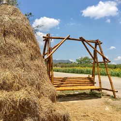 Hay bales on field against sky