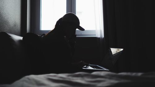 Dog relaxing on bed at home