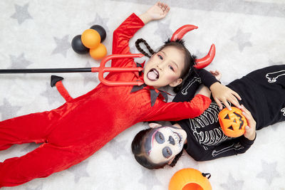 High angle view of girl lying down on floor