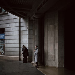 Women walking in corridor of building