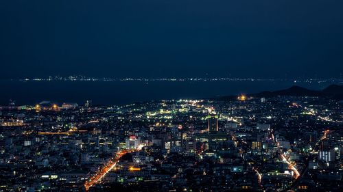 High angle view of illuminated buildings in city at night