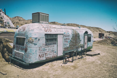 Graffiti on abandoned building against clear sky