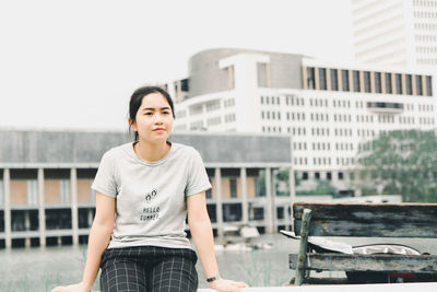 Portrait of teenage girl standing in city