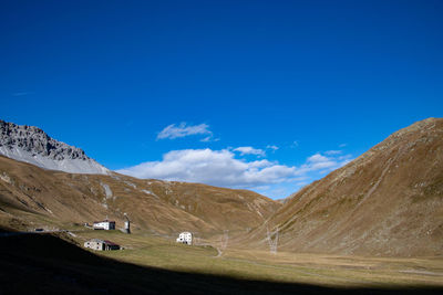 Scenic view of snowcapped mountains against blue sky