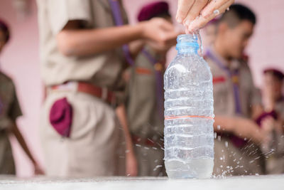 Students wearing uniform with water bottle in foreground