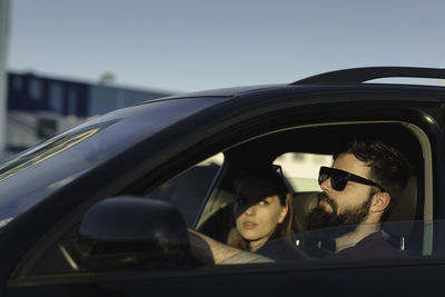 Portrait of a young man sitting in car