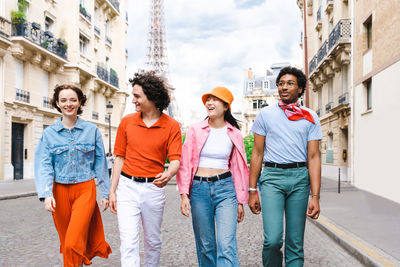 Portrait of smiling friends standing in city