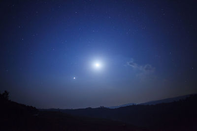 Low angle view of moon in sky at night